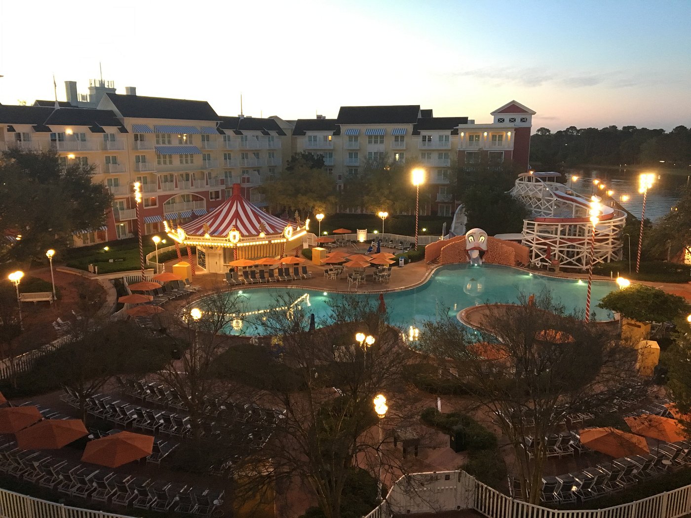 Disney Vacation Club members enjoying a DVC resort poolside at sunset.