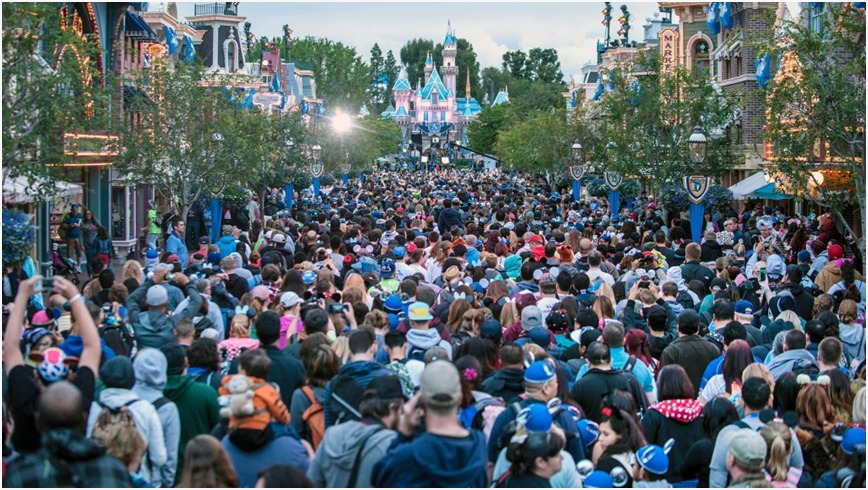 Crowd of excited visitors enjoying Disneyland attractions and Disney Vacation Club amenities.