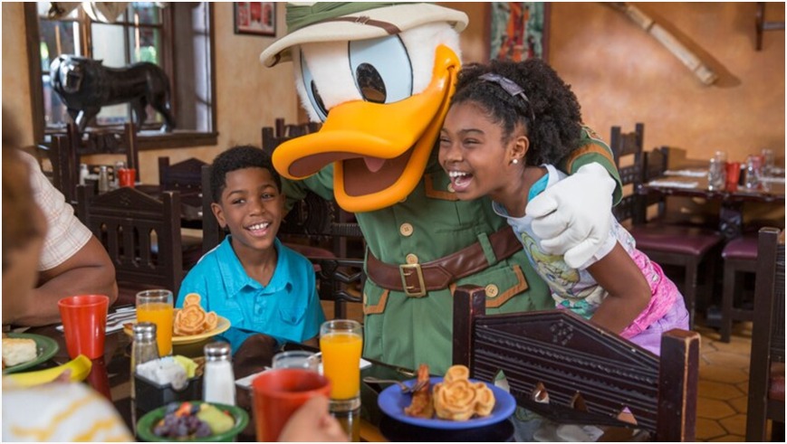 Family enjoying a magical day at Disneyland, surrounded by iconic attractions and Disney characters.